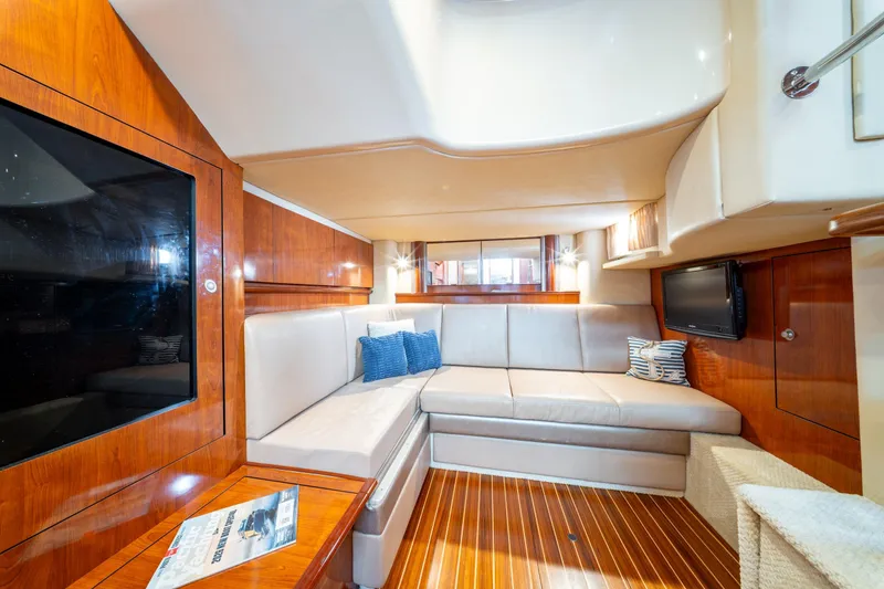  Yacht Photos Pics Luxurious interior of 2004 Sea Ray 390 Sundancer yacht with plush seating and wood finishes.