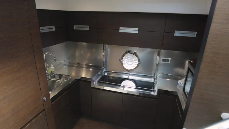  Yacht Photos Pics Modern kitchen in 2008 Azimut 62S yacht with stainless steel appliances and porthole window.