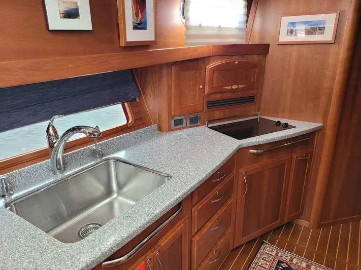 The Dark Side Yacht Photos Pics 2014 Sabre 48 Salon Express kitchen with granite countertops and stainless steel sink.