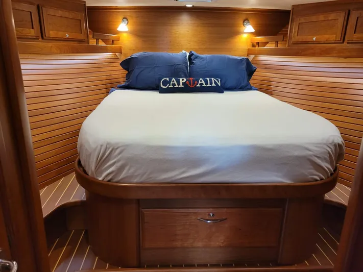 The Dark Side Yacht Photos Pics Luxurious 2014 Sabre 48 Salon Express cabin with cozy bed and wooden interior.