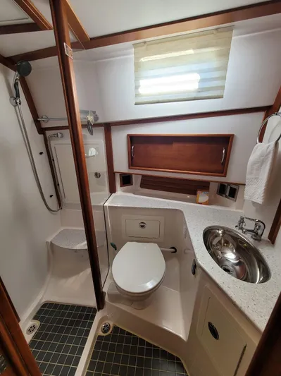 The Dark Side Yacht Photos Pics 2014 Sabre 48 Salon Express bathroom with shower, sink, and toilet.