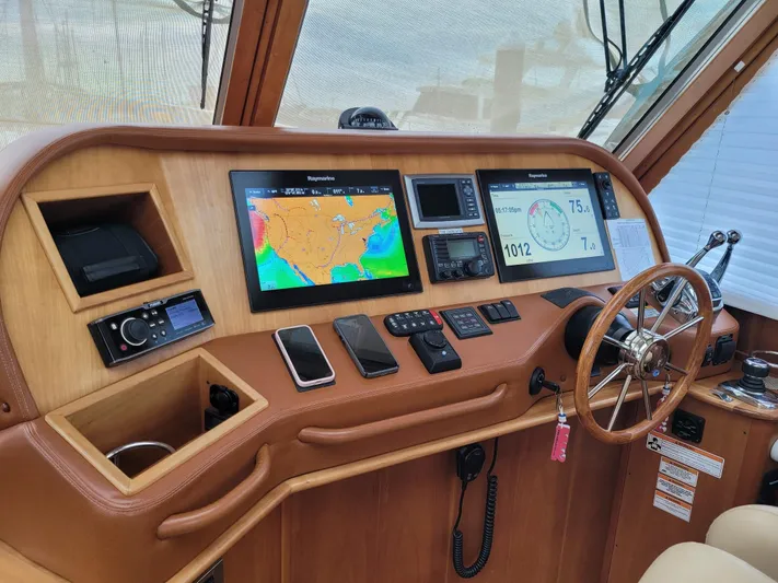 The Dark Side Yacht Photos Pics Helm of 2014 Sabre 48 Salon Express with navigation screens and controls.