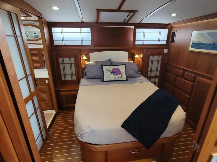 The Dark Side Yacht Photos Pics Luxurious 2014 Sabre 48 Salon Express bedroom with elegant wood finish and cozy bedding.