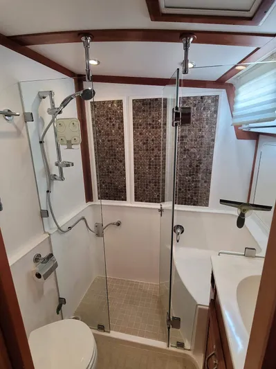 The Dark Side Yacht Photos Pics Luxurious bathroom in 2014 Sabre 48 Salon Express yacht with modern shower and elegant fixtures.
