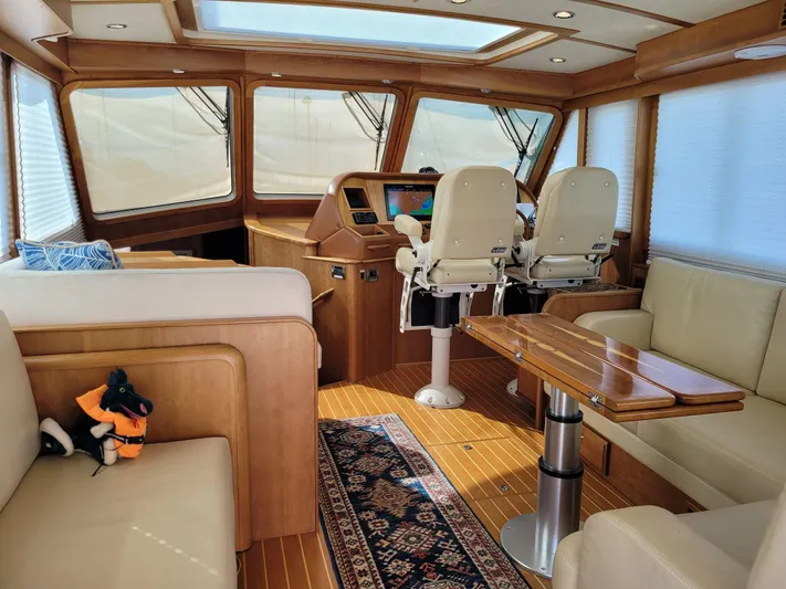 The Dark Side Yacht Photos Pics Luxurious interior of 2014 Sabre 48 Salon Express yacht with plush seating and helm.