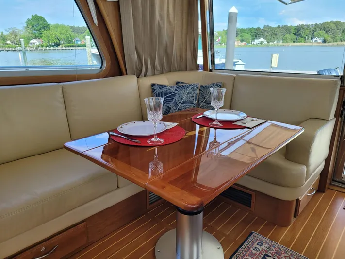 The Dark Side Yacht Photos Pics Interior of 2014 Sabre 48 Salon Express yacht with elegant dining setup.