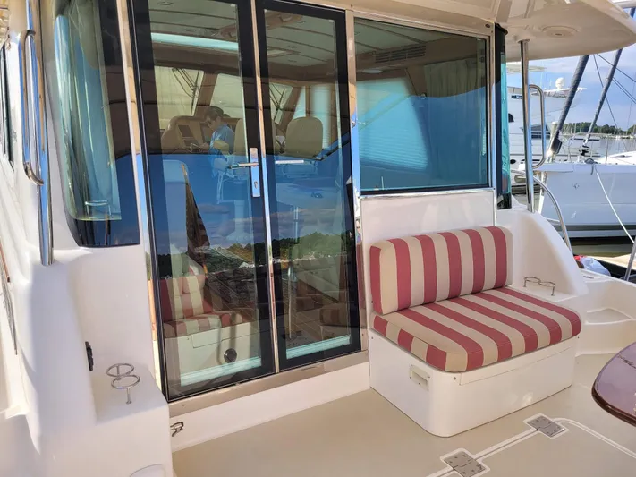 The Dark Side Yacht Photos Pics 2014 Sabre 48 Salon Express yacht with striped seating and glass doors.