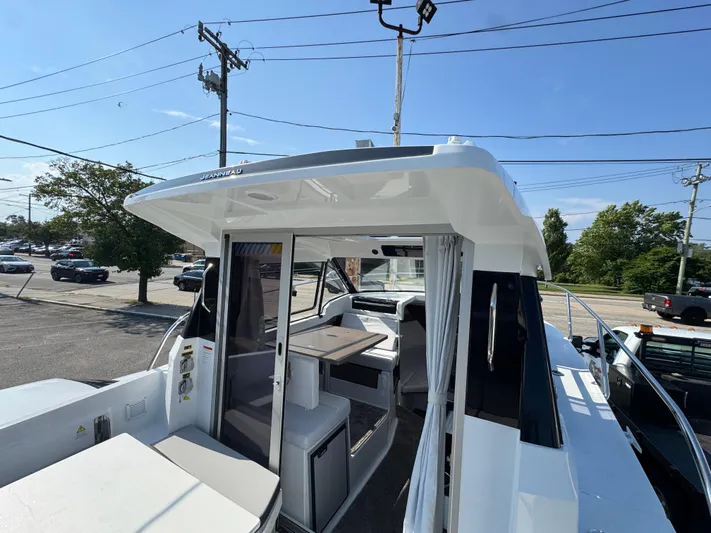  Yacht Photos Pics 2025 Jeanneau NC 795 Series 2 boat with open cabin and seating area.