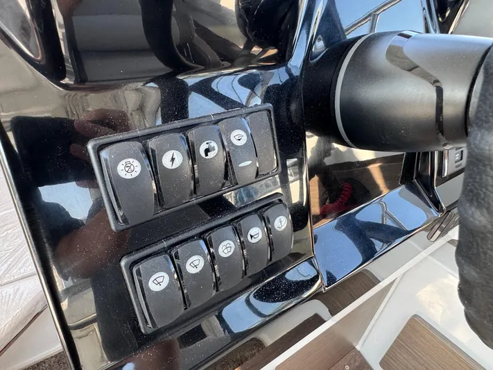  Yacht Photos Pics Control panel of 2025 Jeanneau NC 795 Series 2 boat with various switches.