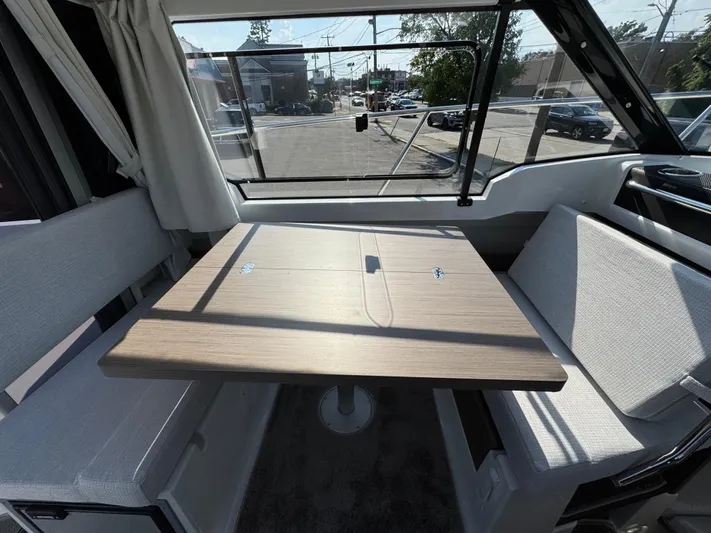  Yacht Photos Pics Interior of 2025 Jeanneau NC 795 Series 2 boat with dining area and large window.