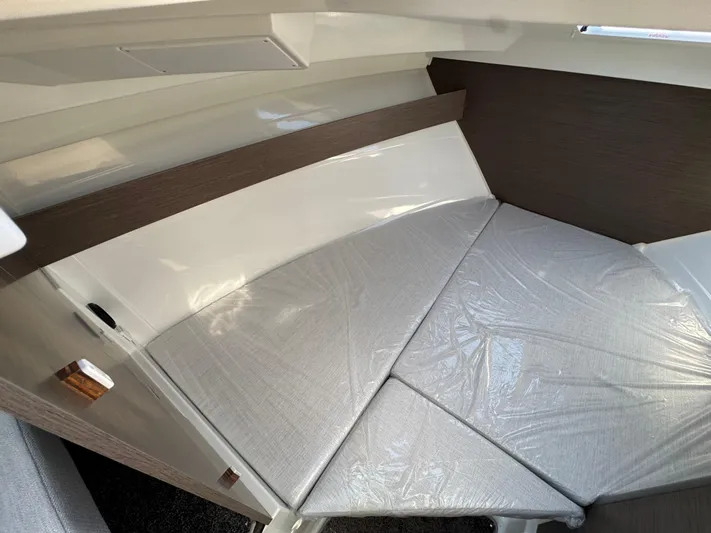  Yacht Photos Pics 2025 Jeanneau NC 795 Series 2 cabin interior with cushioned seating.