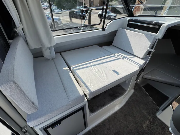  Yacht Photos Pics Interior seating of 2025 Jeanneau NC 795 Series 2 boat, featuring convertible cushions.