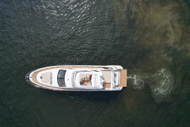 Neena Yacht Photos Pics Aerial view of 2015 Azimut 64 Flybridge yacht cruising on water.