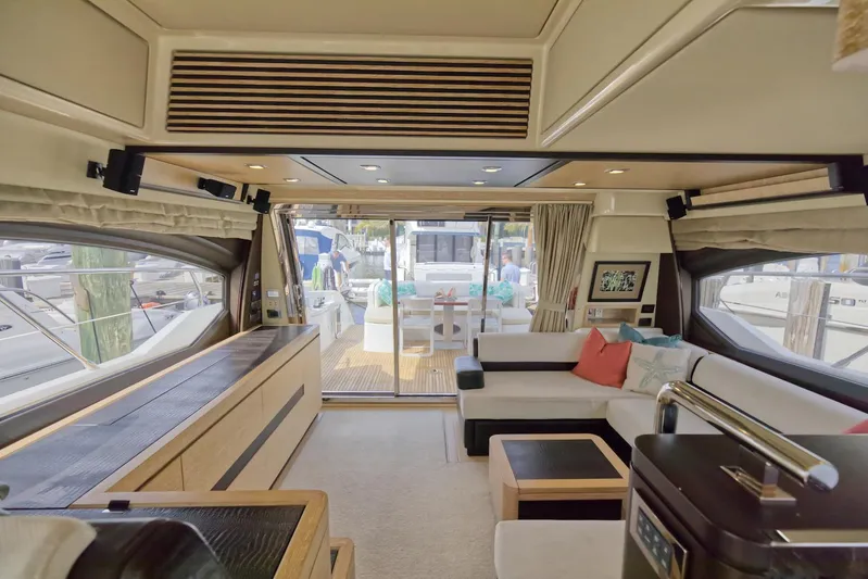 Neena Yacht Photos Pics Luxurious interior of 2015 Azimut 64 Flybridge yacht with modern furnishings and large windows.