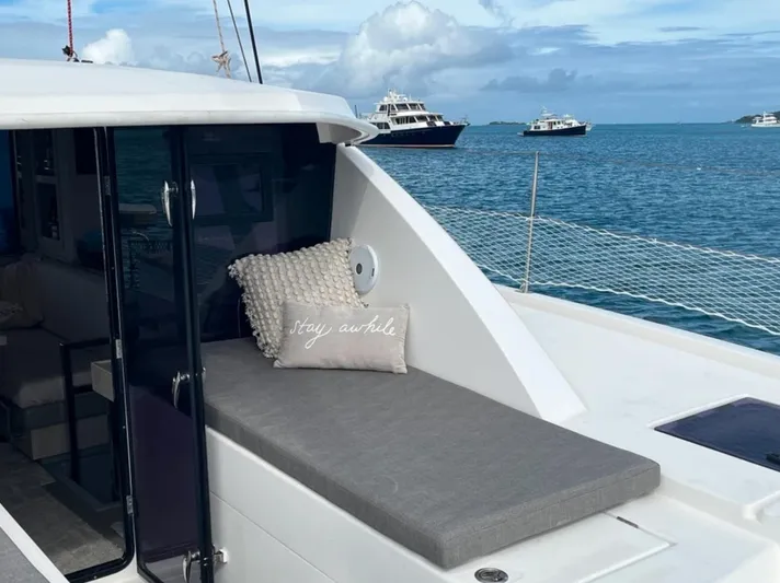  Yacht Photos Pics Leopard 40 catamaran, 2018 model, with cushioned seating, on a serene ocean backdrop.
