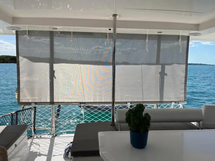 Yacht Photos Pics Leopard 40 catamaran interior with ocean view, featuring sunshade and seating area, 2018 model.
