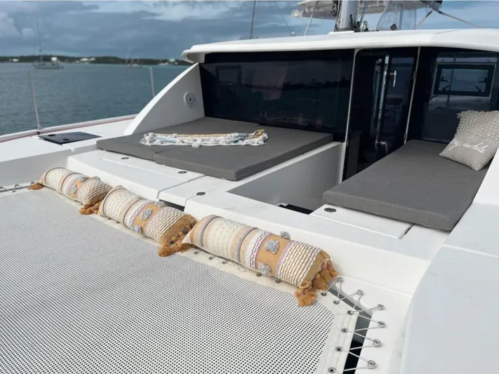  Yacht Photos Pics 2018 Leopard 40 catamaran with cushioned deck and netting, anchored on calm waters.