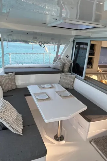  Yacht Photos Pics Leopard 40 catamaran interior with dining area, 2018 model, featuring ocean view.