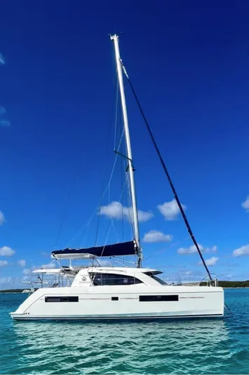  Yacht Photos Pics 2018 Leopard 40 catamaran sailing on clear blue waters under a bright sky.