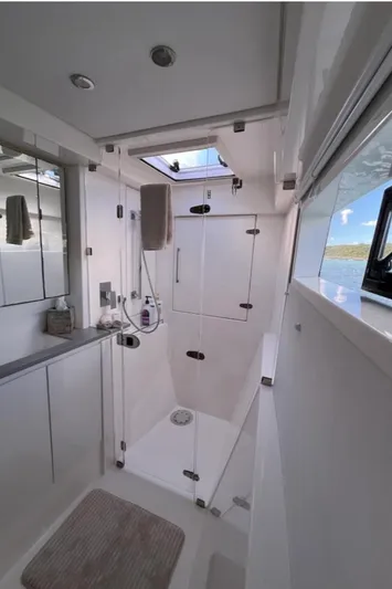  Yacht Photos Pics Modern bathroom on 2018 Leopard 40 yacht with glass shower and ocean view.