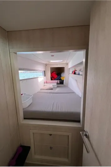 Yacht Photos Pics Interior cabin of a 2018 Leopard 40 catamaran with a cozy bed and storage.
