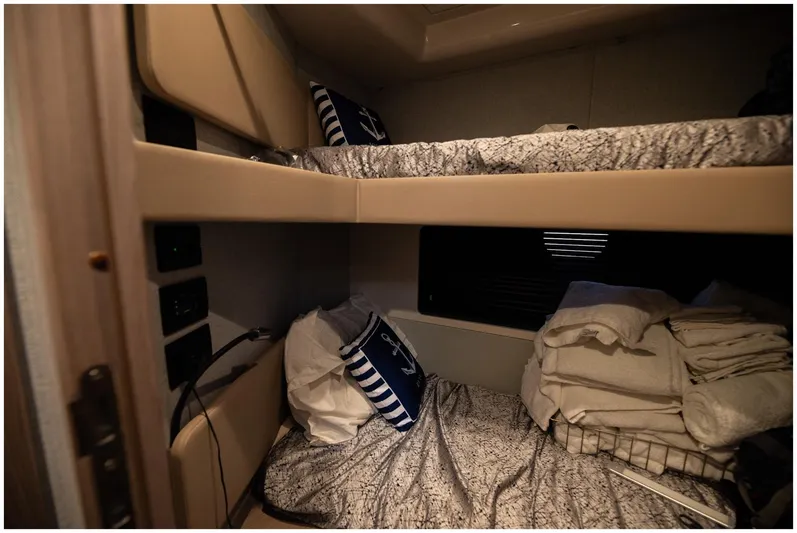  Yacht Photos Pics Bunk beds in 2022 Azimut Fly yacht cabin with nautical-themed pillows and bedding.