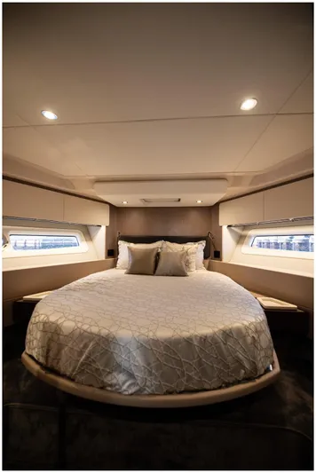  Yacht Photos Pics Luxurious bedroom interior of 2022 Azimut Fly yacht with elegant bedding and ambient lighting.