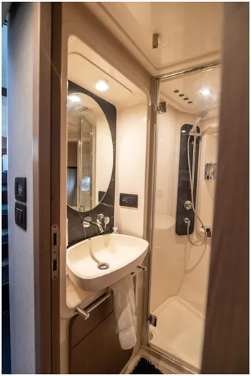  Yacht Photos Pics Luxurious bathroom in 2022 Azimut Fly yacht with modern fixtures and elegant design.