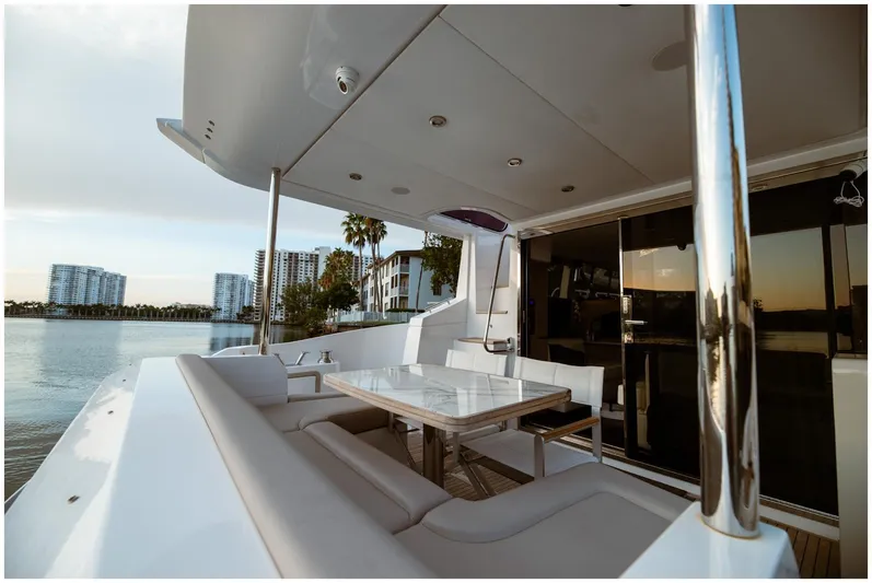  Yacht Photos Pics Luxurious Azimut 2022 Fly yacht deck with seating, table, and waterfront view.