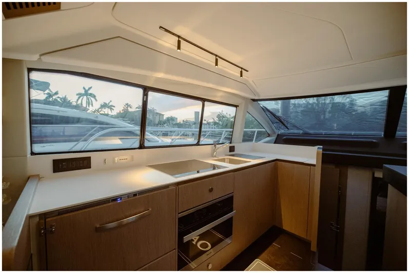 Yacht Photos Pics Modern kitchen interior of 2022 Azimut Fly yacht with sleek design and large windows.