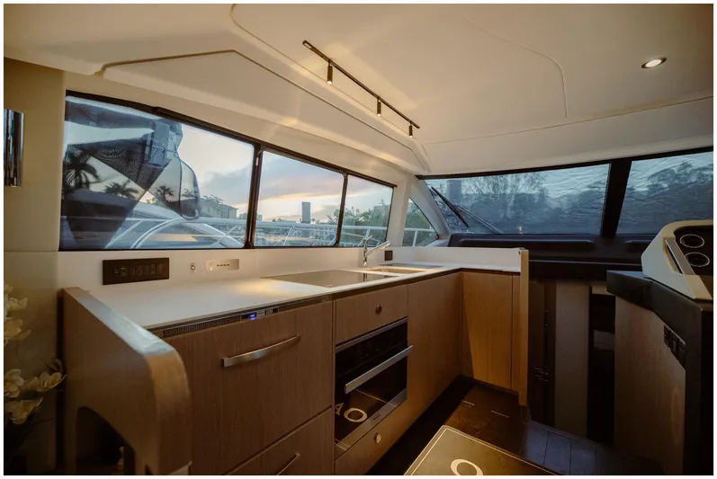  Yacht Photos Pics Modern kitchen interior of 2022 Azimut Fly yacht with sleek design and panoramic windows.