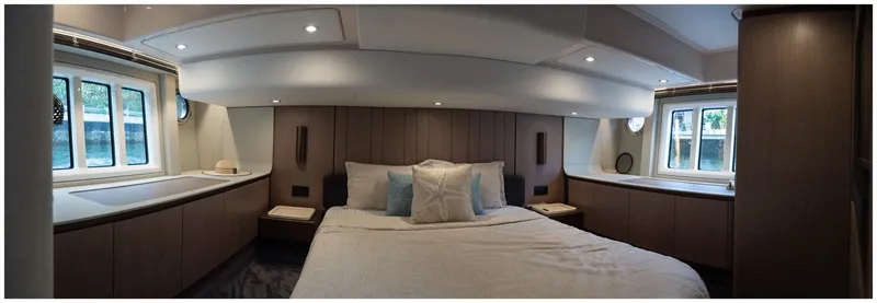  Yacht Photos Pics Luxurious bedroom interior of 2022 Azimut Fly yacht, featuring elegant design and ample natural light.