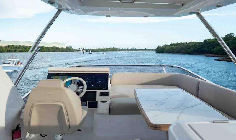  Yacht Photos Pics Flybridge view of 2022 Azimut 50 Fly yacht, featuring helm and seating area.