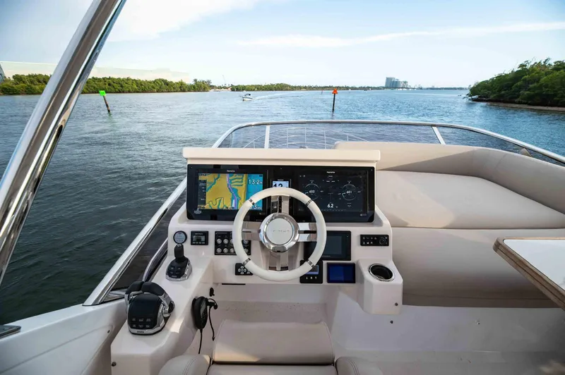  Yacht Photos Pics Cockpit view of 2022 Azimut 50 Fly yacht with navigation screens and steering wheel.