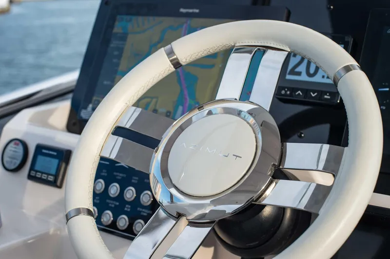  Yacht Photos Pics Steering wheel of 2022 Azimut 50 Fly yacht with navigation display.