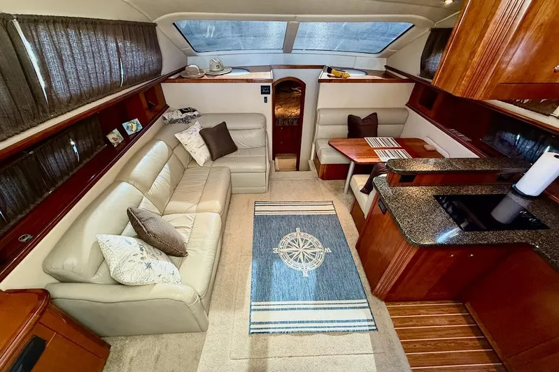 No Worries Yacht Photos Pics Luxurious interior of 2006 Cruisers Yachts 415 Express Motoryacht with elegant seating and kitchen area.