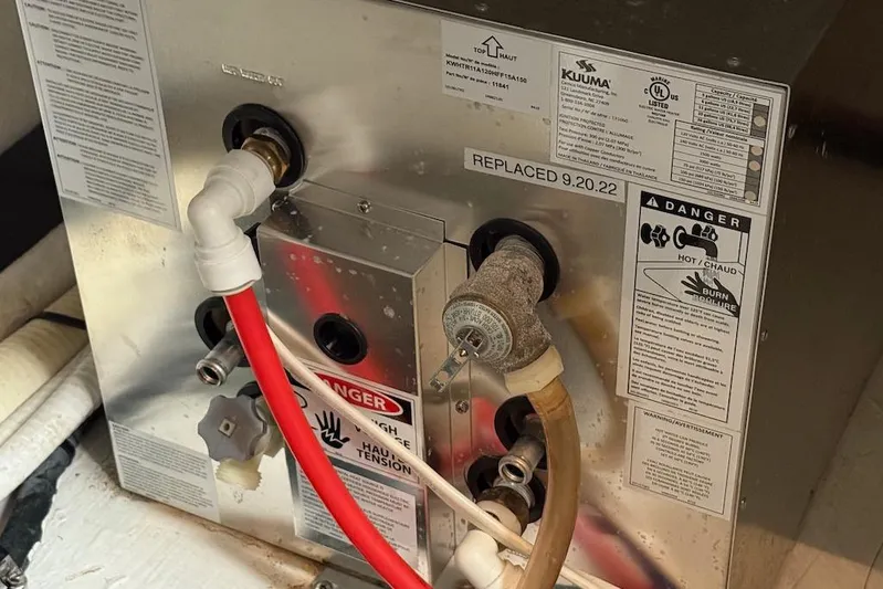 No Worries Yacht Photos Pics 2006 Cruisers Yachts 415 Express Motoryacht water heater with safety warnings and replacement date.