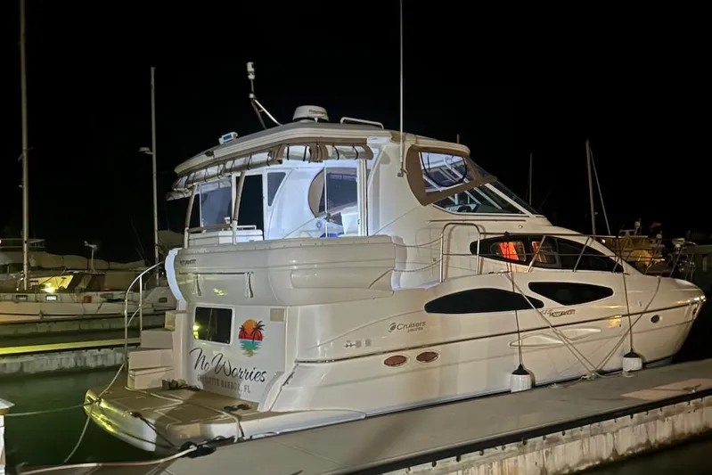 No Worries Yacht Photos Pics 2006 Cruisers Yachts 415 Express Motoryacht docked at night, illuminated and serene.