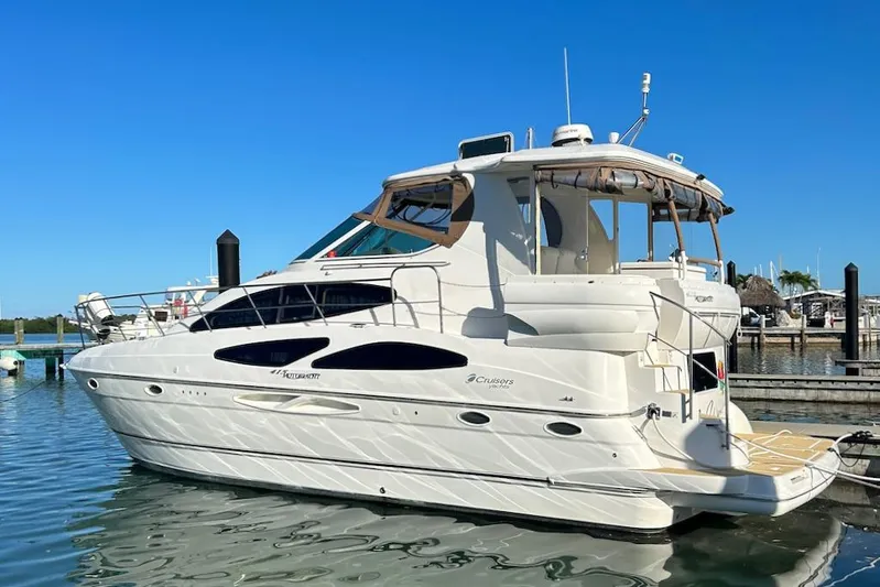No Worries Yacht Photos Pics 2006 Cruisers Yachts 415 Express Motoryacht docked in a marina under clear blue skies.