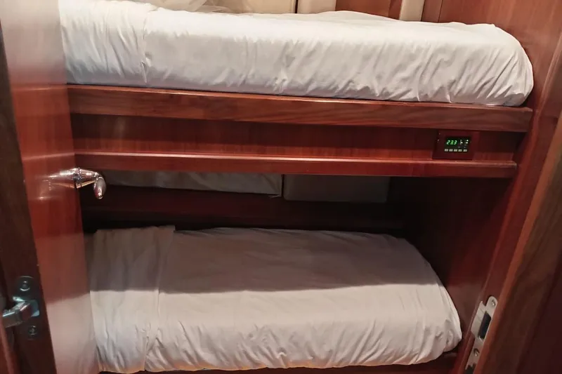  Yacht Photos Pics Bunk beds in 2006 Sunseeker Predator 82 yacht cabin, featuring wooden finish and digital display.