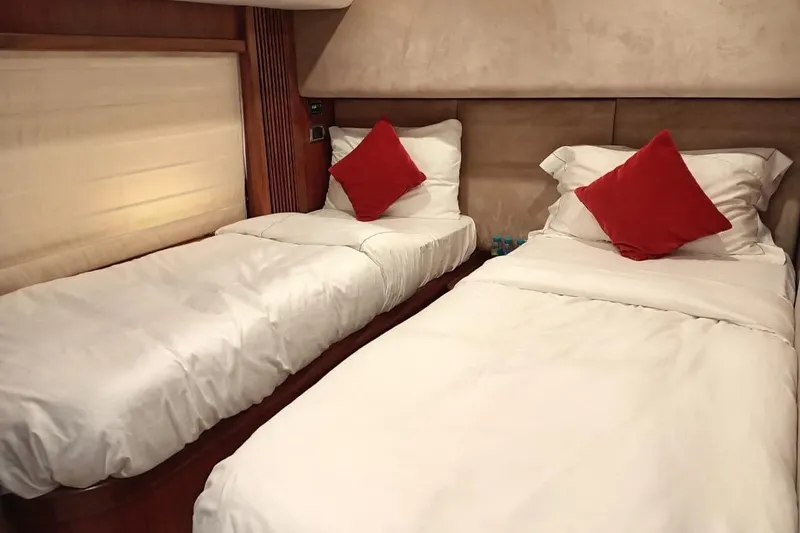  Yacht Photos Pics Luxurious twin cabin in 2006 Sunseeker Predator 82 yacht with red accent pillows.