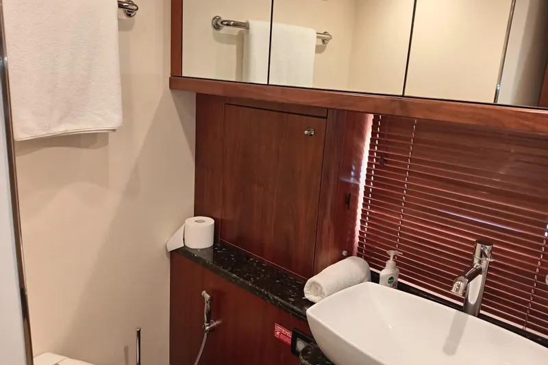  Yacht Photos Pics Luxurious bathroom in 2006 Sunseeker Predator 82 yacht with modern sink and wooden accents.