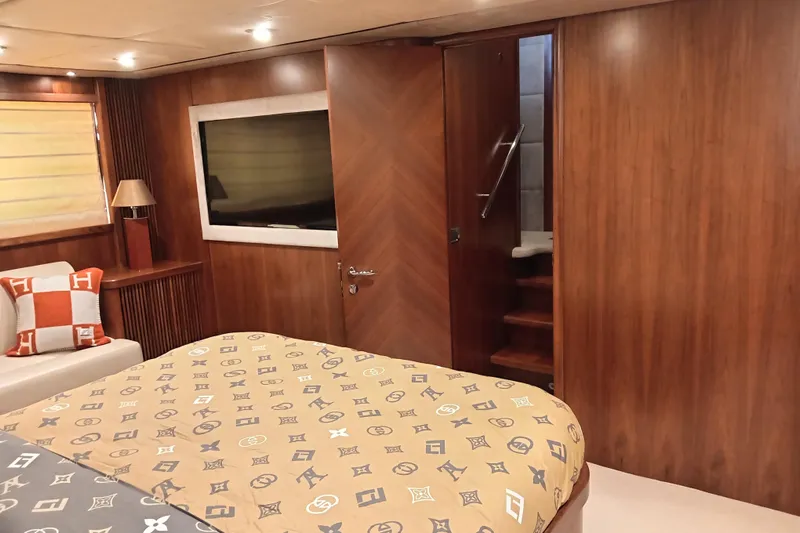  Yacht Photos Pics Luxurious cabin interior of 2006 Sunseeker Predator 82 yacht with elegant wood paneling.