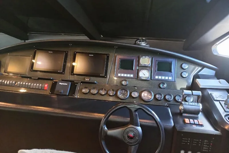  Yacht Photos Pics Control panel of a 2006 Sunseeker Predator 82 yacht with multiple gauges and screens.