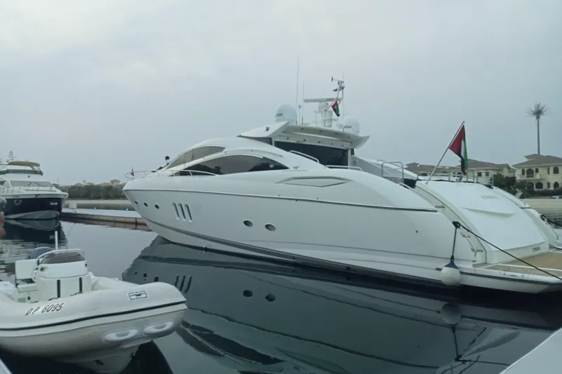  Yacht Photos Pics Luxury 2006 Sunseeker Predator 82 yacht docked in a serene marina setting.