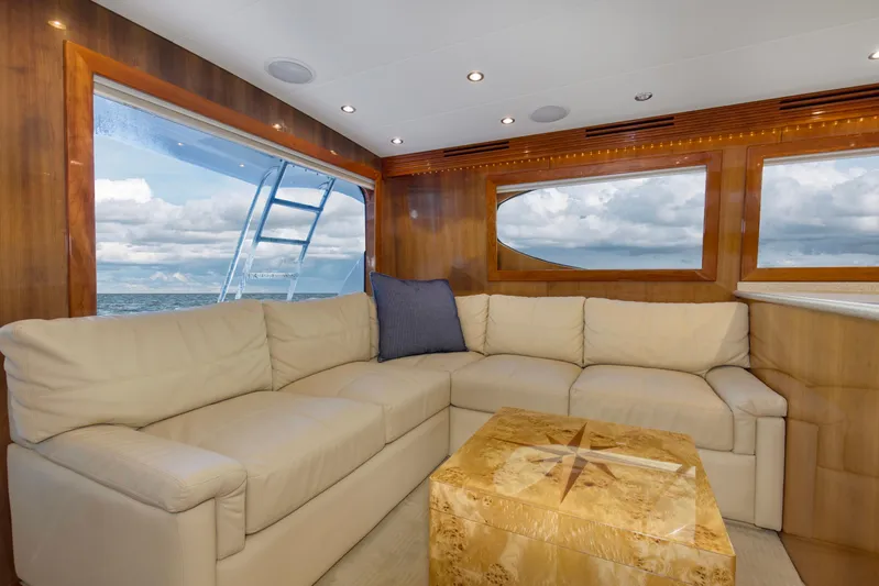 Lady A Yacht Photos Pics Luxurious interior of 2008 Hatteras 54 Convertible yacht with cream sofa and ocean view.
