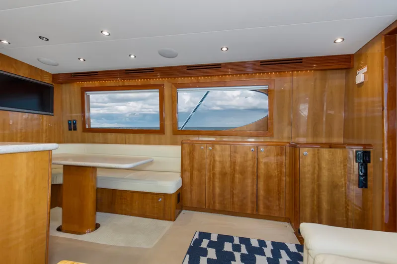Lady A Yacht Photos Pics Luxurious interior of 2008 Hatteras 54 Convertible yacht with wood paneling and ocean view.
