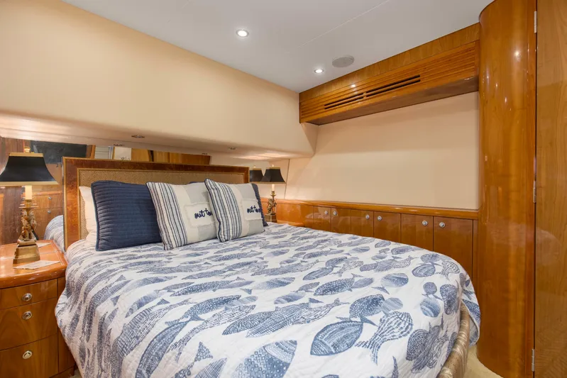 Lady A Yacht Photos Pics Luxurious bedroom interior of 2008 Hatteras 54 Convertible yacht with elegant wood finishes.