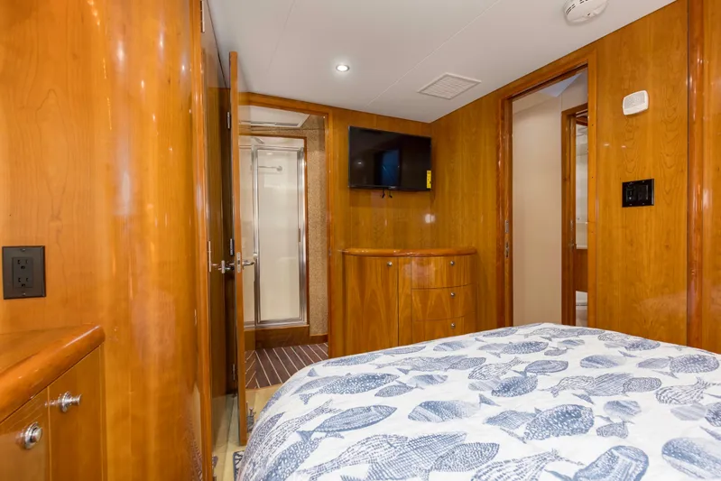 Lady A Yacht Photos Pics Interior of 2008 Hatteras 54 Convertible yacht bedroom with wood paneling and TV.