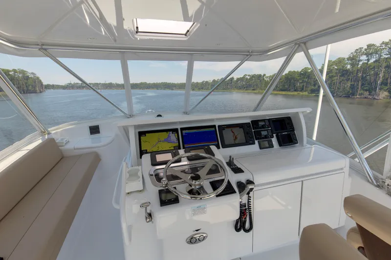 Lady A Yacht Photos Pics Helm of 2008 Hatteras 54 Convertible yacht with navigation screens and steering wheel.
